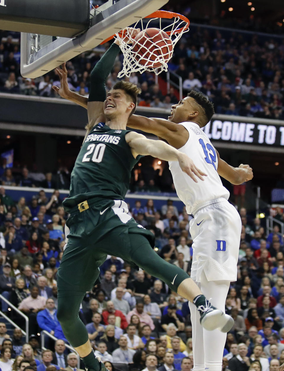 Michigan State guard Matt McQuaid (20) scores against Duke forward Javin DeLaurier (12) during the first half of an NCAA men's East Regional final college basketball game in Washington, Sunday, March 31, 2019. (AP Photo/Alex Brandon)