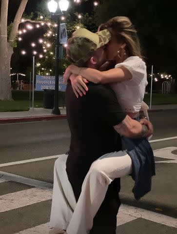 <p>Adriana Patridge/Instagram</p> Audrina Patridge and Michael Ray kissing in an Instagram Story she shared in June 2024