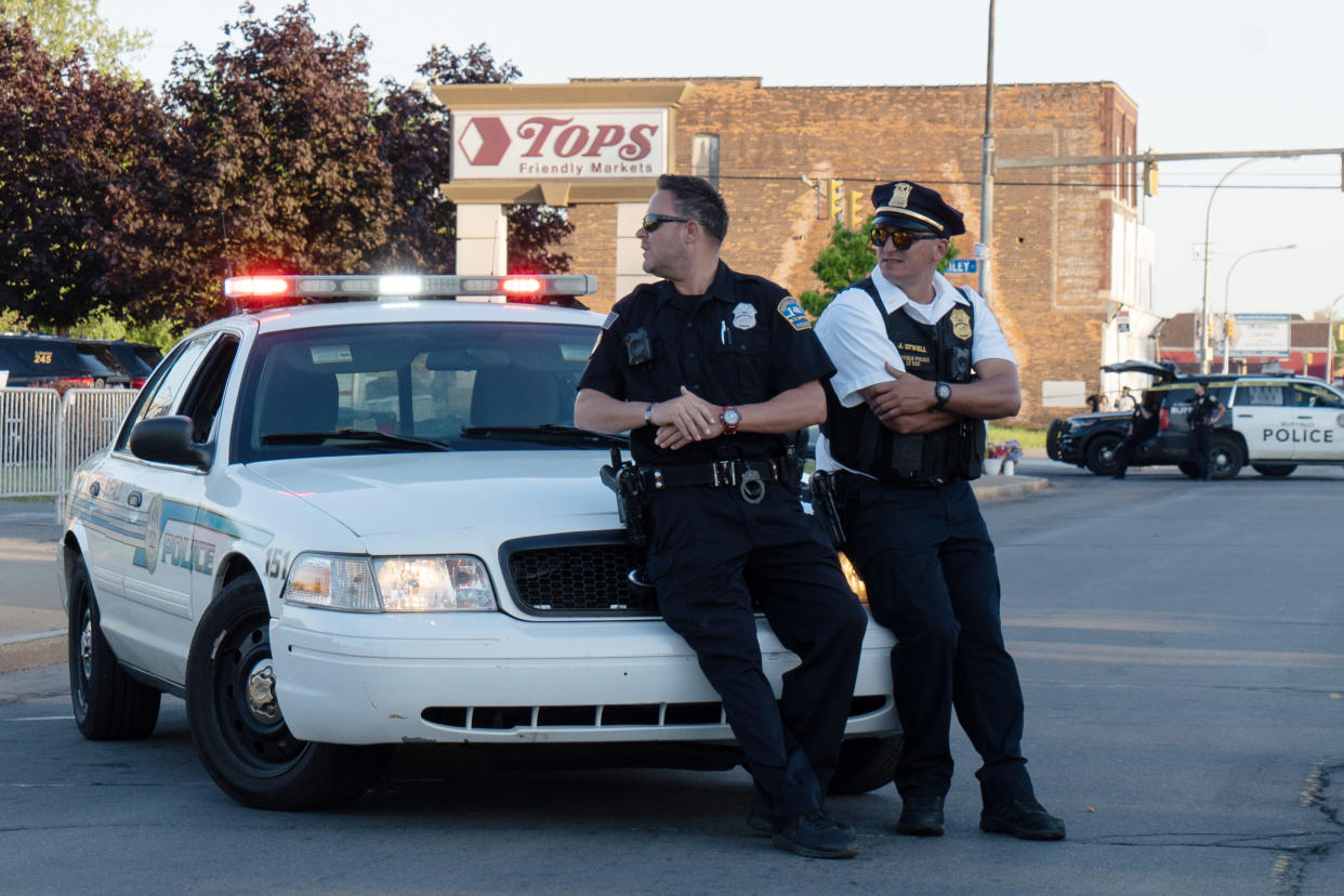 Officers guard the crime scene outside Tops supermarket in Buffalo, N.Y., on Sunday evening.  (Joshua Thermidor for NBC News)