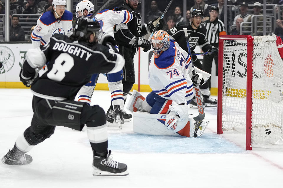 Los Angeles Kings defenseman Drew Doughty, left, scores on Edmonton Oilers goaltender Stuart Skinner during the second period in Game 3 of an NHL hockey Stanley Cup first-round playoff series Friday, April 26, 2024, in Los Angeles. (AP Photo/Mark J. Terrill)