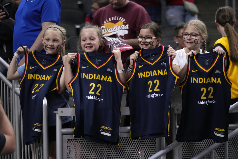 Fans watch Indiana Fever guard Caitlin Clark warm up for the team's WNBA basketball game against the New York Liberty, Thursday, May 16, 2024, in Indianapolis. (AP Photo/Michael Conroy)