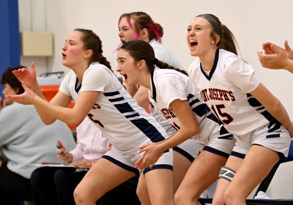 The Saint Joseph’s bench erupts in cheers after a basket during the game against Millersburg on Wednesday, Jan. 17, 2024.