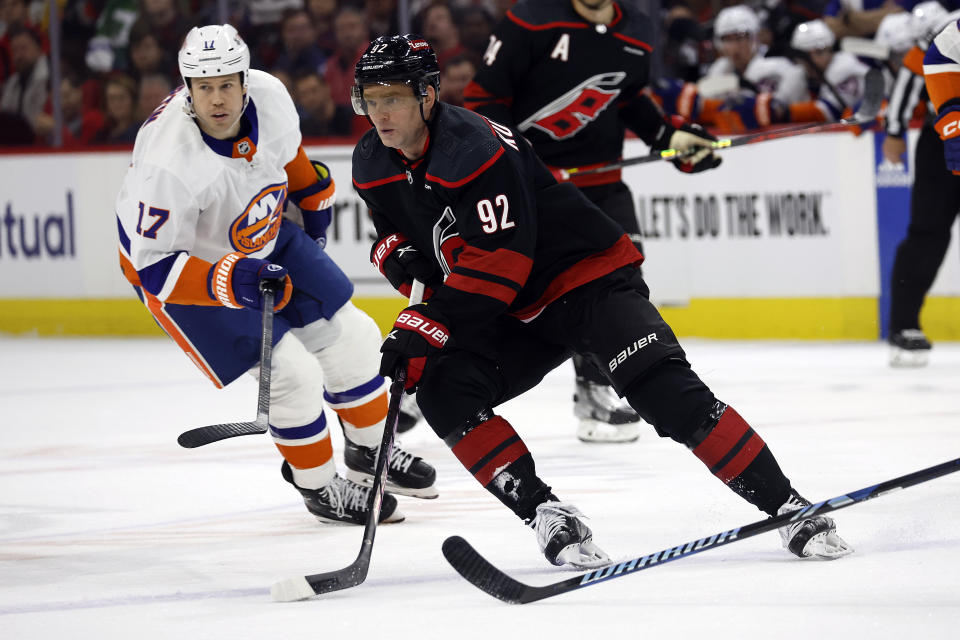 Carolina Hurricanes' Evgeny Kuznetsov (92) controls the puck in front of New York Islanders' Matt Martin (17) during the second period in Game 2 of an NHL hockey Stanley Cup first-round playoff series in Raleigh, N.C., Monday, April 22, 2024. (AP Photo/Karl B DeBlaker)
