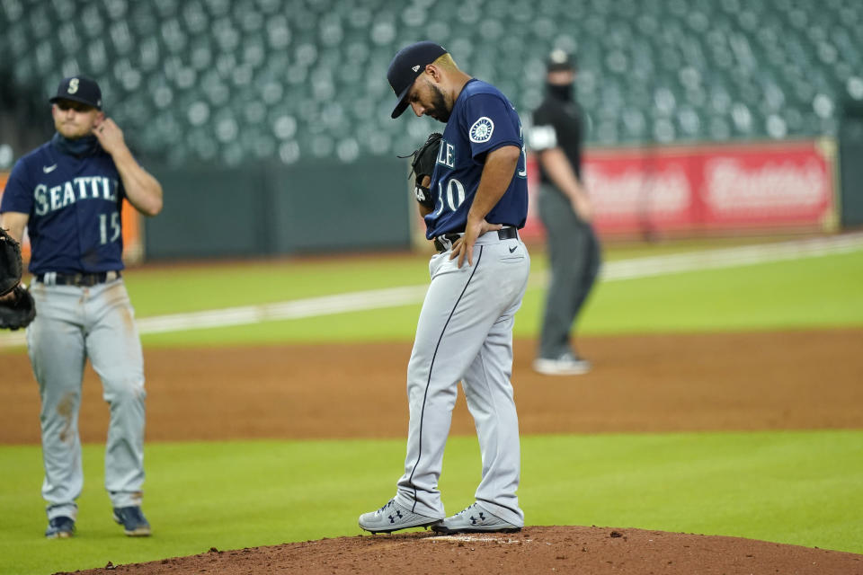 Seattle Mariners starting pitcher Nestor Cortes (30) waits for manager Scott Servais to make his way to the mound to pull him during the first inning of a baseball game against the Houston Astros Friday, Aug. 14, 2020, in Houston. (AP Photo/David J. Phillip)