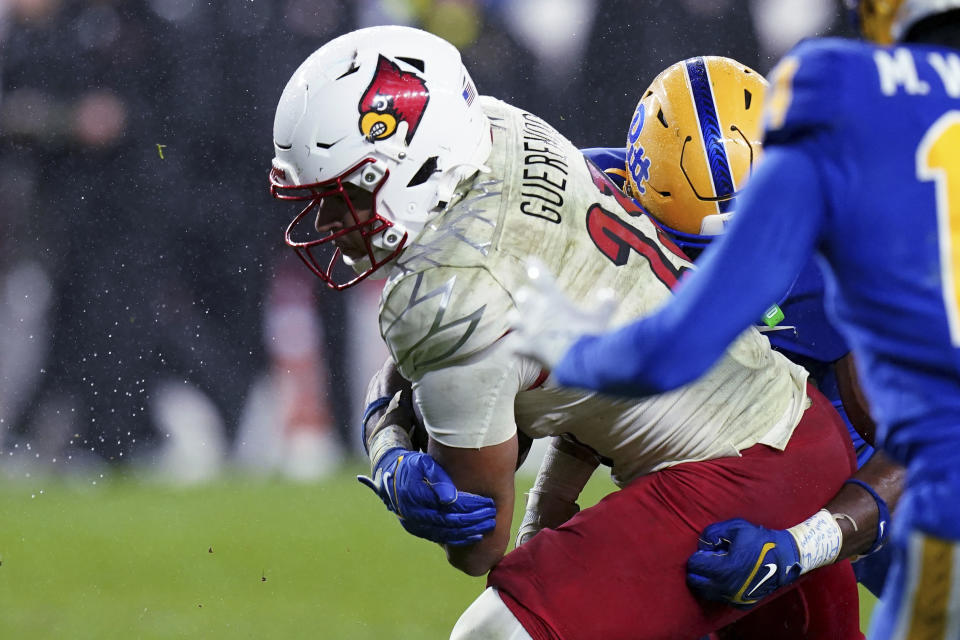 Louisville running back Isaac Guerendo (23) scores a touchdown against Pittsburgh during the first half of an NCAA college football game in Pittsburgh, Saturday, Oct. 14, 2023. (AP Photo/Matt Freed)