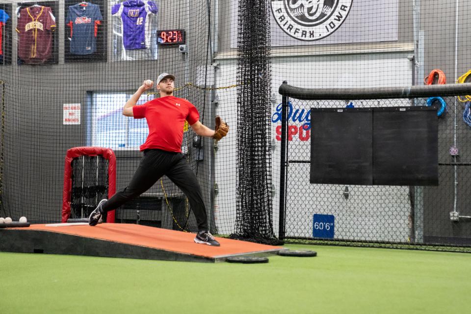 Iowa native Connor Van Scoyoc, a minor-league pitcher for the Los Angeles Angels, throws a pitch during a bullpen session at Dugout Sports in Fairfax on Jan. 24.