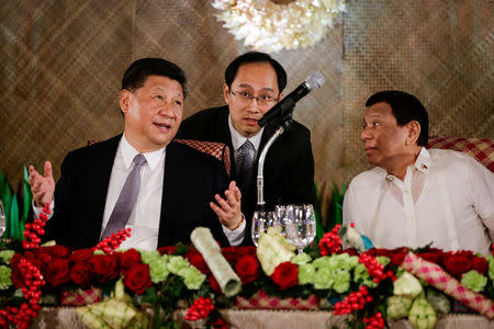 China's President Xi Jinping speaks as Philippine President Rodrigo Duterte listens during a State Banquet at the Malacanang presidential palace in Manila, Philippines, November 20, 2018. Mark Cristino/Pool via Reuters