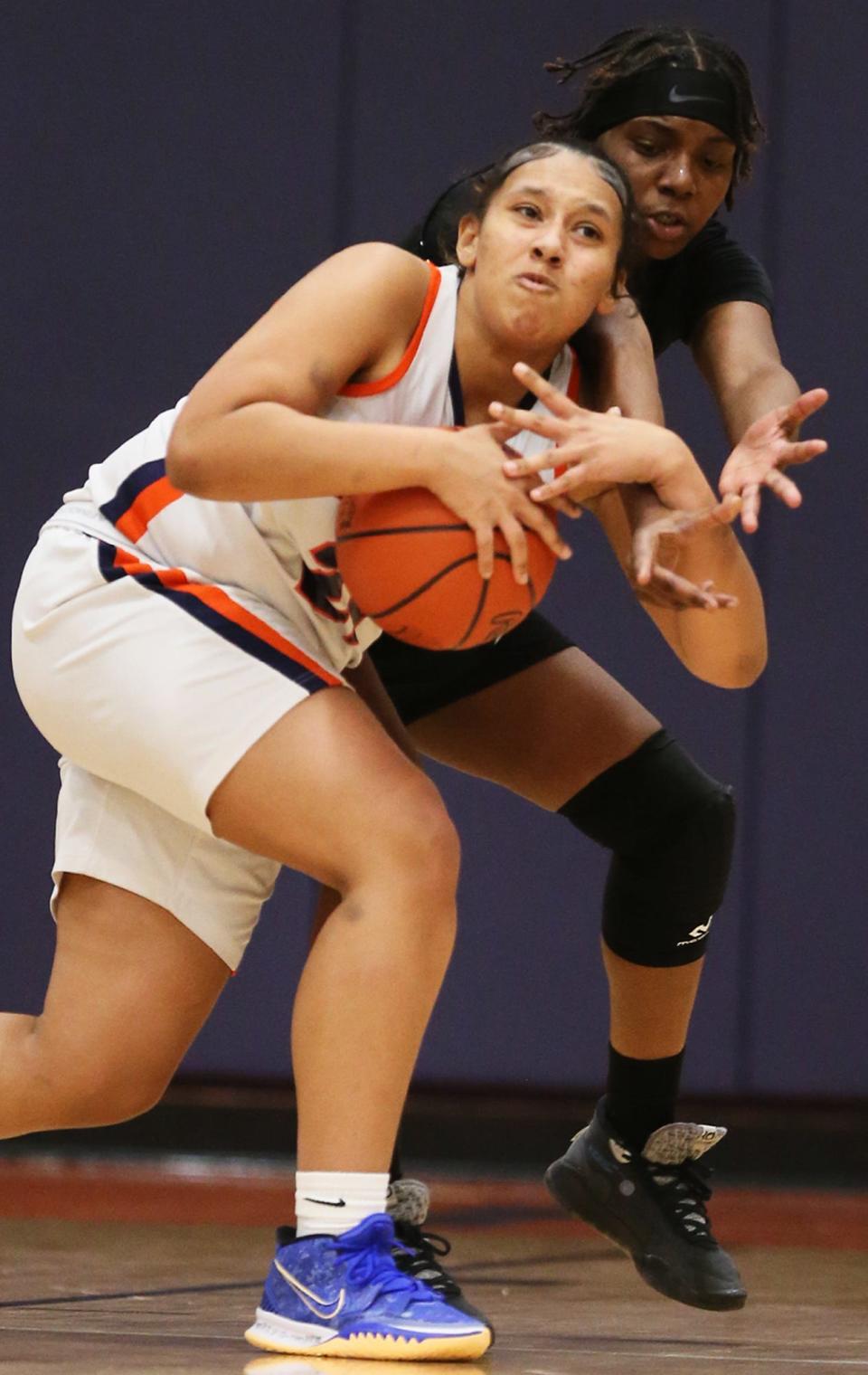 Ellet's Trey Moore and Buchtel's Cassidy Blackmon battle for a rebound in the first half of Ellet's 63-24 win Monday night. [Mike Cardew/Beacon Journal]