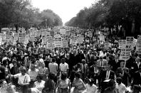 FILE - In this Aug. 28, 1963, file photo Dr. Martin Luther King Jr., center left with arms raised, marches along Constitution Avenue with other civil rights protestors carrying placards, from the Washington Monument to the Lincoln Memorial during the March on Washington. The annual celebration of the Martin Luther King Jr. holiday in his hometown in Atlanta is calling for renewed dedication to nonviolence following a turbulent year. The slain civil rights leader's daughter, the Rev. Bernice King, said in an online church service Monday, Jan. 18, 2021, that physical violence and hateful speech are “out of control” in the aftermath of a divisive election followed by a deadly siege on the U.S. Capitol in Washington by supporters of President Donald Trump. (AP Photo, File)