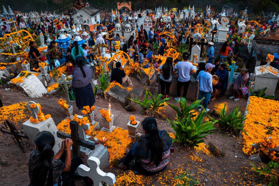 Mixtec indigenous people take part in the Day of the Dead celebrations at a cemetery on November 2, 2021 in Xalpatláhuac, Mexico. Day of the Dead (Día de Muertos), a religious holiday combining the death veneration rituals of Pre-Hispanic cultures with the Catholic practice, is widely celebrated throughout all of Mexico. Based on the belief that the souls of the departed may come back to this world on that day, people gather to pray, eat, drink or play music, to remember friends or family members who have died and to support their souls on the spiritual journey.