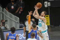 Charlotte Hornets forward Gordon Hayward (20) shoots over New York Knicks guard Austin Rivers in the first quarter of an NBA basketball game in Charlotte, N.C., Monday, Jan. 11, 2021. (AP Photo/Nell Redmond)