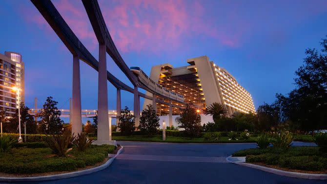 an evening view of walt disney world's monorail going into disney's contemporary resort