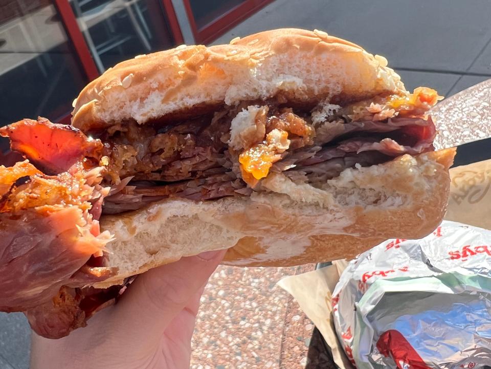 brisket sandwich with a bite arby's