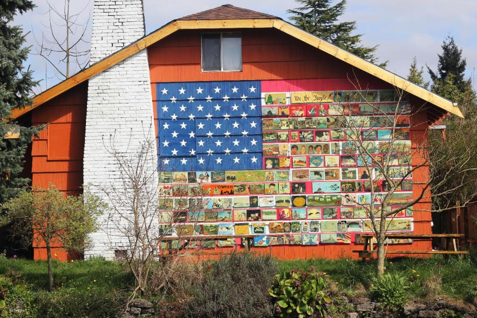 This April, 2013 photo shows Richard Ormbrek's house, decorated with a 20-foot wide American flag made up of 180 individually-painted tiles, in Seattle. (AP Photo/Cedar Burnett)