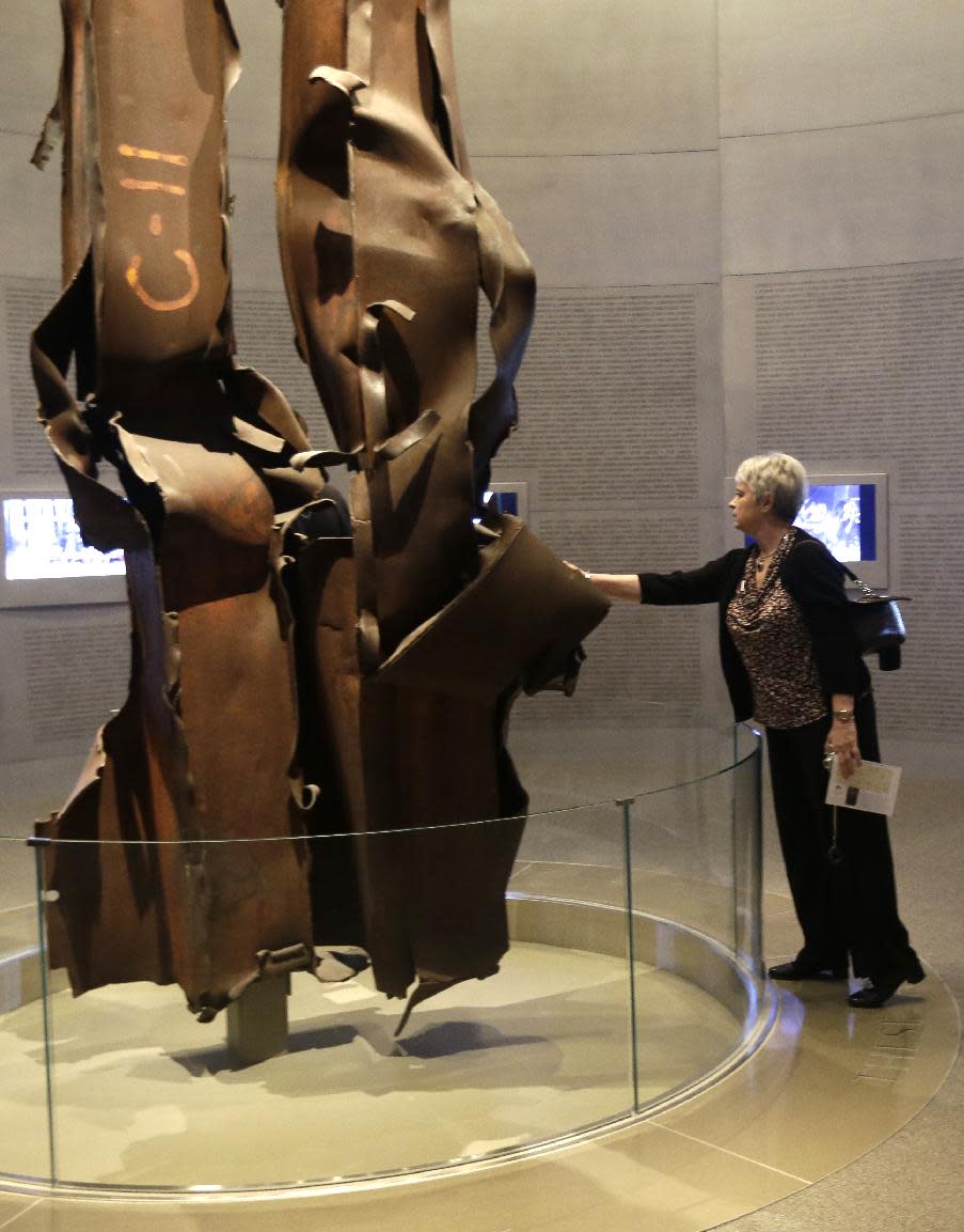 File-This May 1, 2013, file photo shows Deborah Jurcak of Grapevine, Texas, leaning over to touch the World Trade Center tower beams in the 9/11 exhibit in the George W. Bush Presidential Library and Museum in Dallas. The George W. Bush Presidential Library and Museum is set to begin accepting Freedom of Information Act requests for records from Bush’s presidency. The library will start taking requests Monday Jan. 20, 2014, which marks five years from the end of Bush’s presidency. (AP Photo/Tony Gutierrez, File)