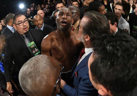 Dec 17, 2016; Los Angeles, CA, USA; Bernard Hopkins reacts as he receives medical attention after he fell out of the ring in seventh round. Hopkins did not return to the ring in the required 20 seconds and Joe Smith Jr. was awarded the win on a TKO in their light heavyweight boxing fight at The Forum. Mandatory Credit: Jayne Kamin-Oncea-USA TODAY Sports