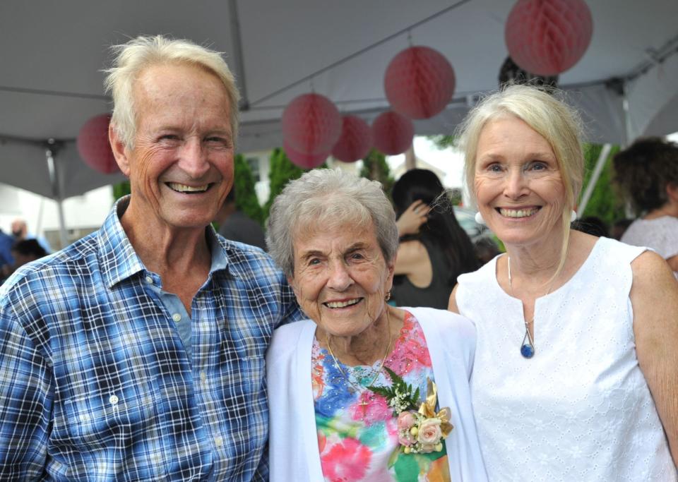 Josephine Jo Sharp, center, is joined by her son, Alan Sharp, left, and daughter, Nancy McGrory, right, during her 100th birthday celebration at her Braintree home. Saturday, July 22, 2023.