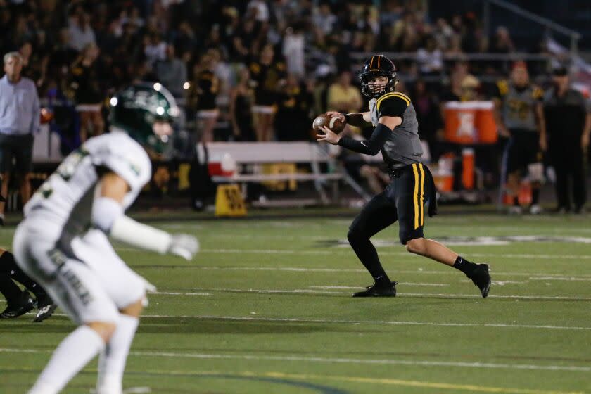 THOUSAND OAKS, CA - SEPTEMBER 16: Newbury Park quarterback Brady Smigiel (7) draws back for a pass against Royal on Friday, Sept. 16, 2022 in Thousand Oaks, CA. (Jason Armond / Los Angeles Times)