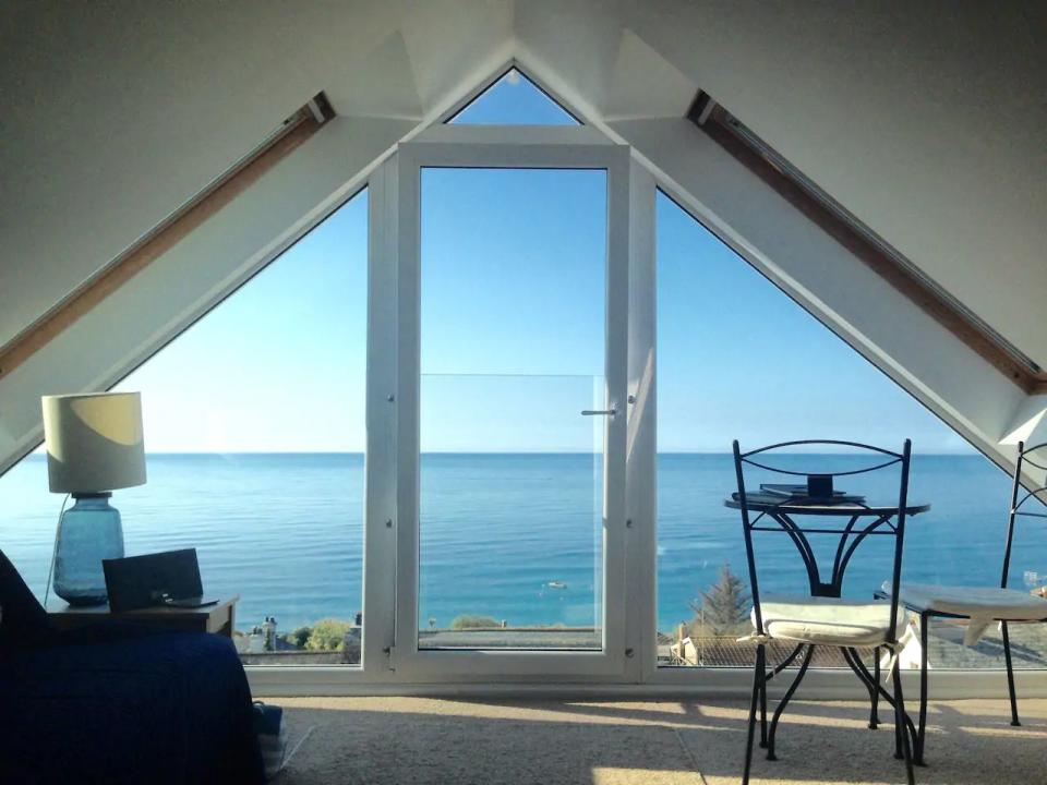 <p>Looking for an Airbnb in Cornwall with an unbeatable sea view? This holiday cottage allows you to wake up to this spectacular scene and enjoy it from your bed. Whether you're having breakfast or watching the sunset, this loft studio is all about the view.</p><p>It's located around 200 metres from the beach so when you're not taking it in from a height, you can make the most of long, coastal walks. The perfect little couples' retreat, this Airbnb has everything you need for a mini-break on Cornwall's South East coast.</p><p><strong>Sleeps</strong>: 2</p><p><strong>Price per night:</strong> £145</p><p><strong>Why we love it:</strong> That view. We could stare at it all day long!</p><p><a class="link " href="https://go.redirectingat.com?id=127X1599956&url=https%3A%2F%2Fwww.airbnb.co.uk%2Frooms%2F13808385&sref=https%3A%2F%2Fwww.countryliving.com%2Fuk%2Ftravel-ideas%2Fstaycation-uk%2Fg32930188%2Fairbnb-cornwall-devon%2F" rel="nofollow noopener" target="_blank" data-ylk="slk:SEE INSIDE;elm:context_link;itc:0;sec:content-canvas">SEE INSIDE</a></p>