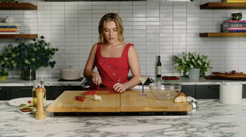 Florence slices cherry tomatoes as she talks