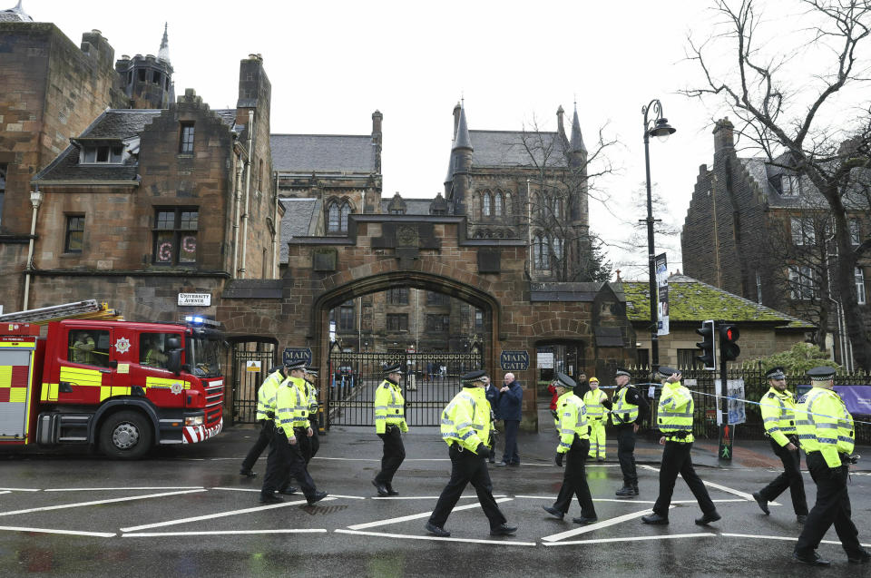 Police and fire services outside the University of Glasgow after the building was evacuated when a suspect package was found in the mailroom, in Glasgow, Scotland, Wednesday March 6, 2019. Buildings at the University of Glasgow were evacuated Wednesday as police examined a suspicious package found in the mailroom, a day after three London transport hubs received letter bombs. (Andrew Milligan/PA via AP)