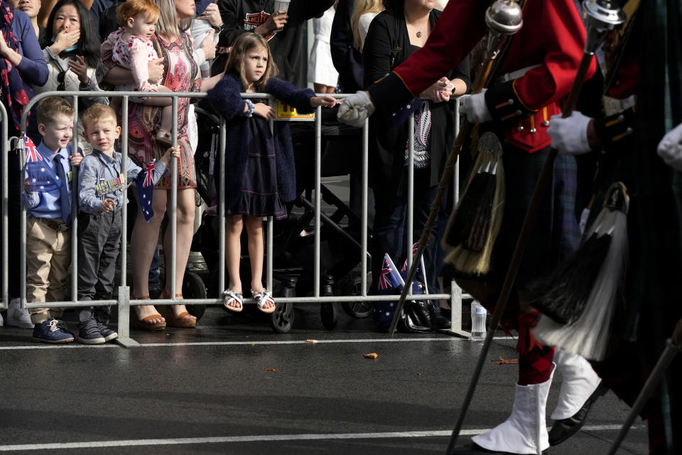 Children watch the Anzac Day march in Sydney, Monday, April 25, 2022. Australia and New Zealand commemorate Anzac Day every April 25, the date in 1915 when the Australia and New Zealand Army Corps landed on Turkey in an ill-fated campaign that created the soldiers' first combat of World War I. (AP Photo/Rick Rycroft)