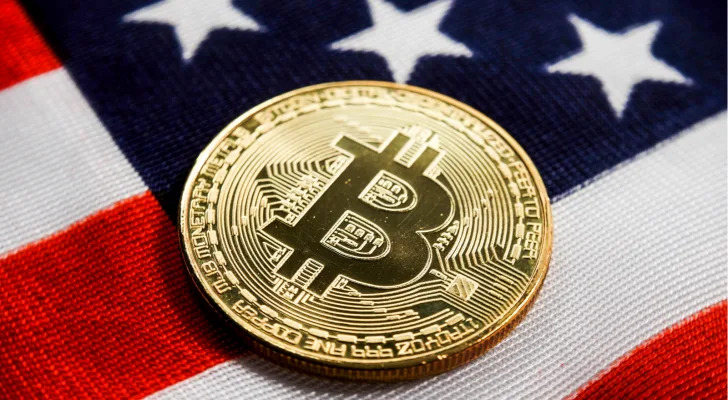 Crypto currency bitcoin btc golden bit coin against flag of United States of America USA.