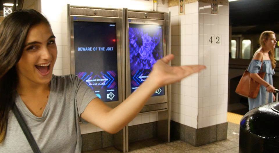 Krause on the subway posing with a billboard and a commuter in the dress. (Photo: blueofftheshoulderdress.tumblr.com)