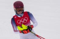 FILE - Mikaela Shiffrin, of the United States, skis down after falling the women's combined slalom at the 2022 Winter Olympics, Thursday, Feb. 17, 2022, in the Yanqing district of Beijing. Shiffrin isn't putting the same pressure on herself for the upcoming world championships, starting on on Feb. 6, 2023 in Courchevel and Meribel, France, that she did for last year's Beijing Olympics. The event is Shiffrin's first major championship since American skier didn't win a medal and didn't finish three of her five races at the Olympics. (AP Photo/Luca Bruno, File)