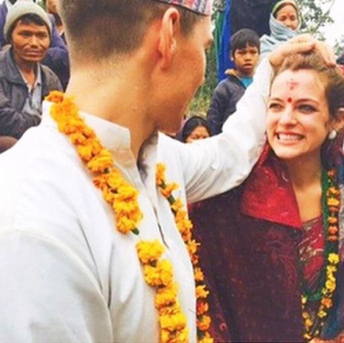 Riley dressed in red at her Nepal wedding with Ben