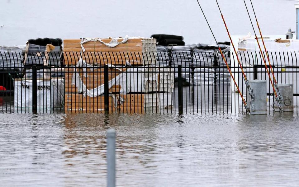 Water rises around supplies stored outdoors at flooded businesses on Northwest 73rd Ave in West Miami-Dade on Wednesday. Heavy rains that have fallen over several days have caused flooding in some neighborhoods.