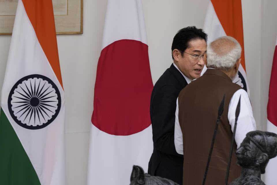 Japan’s Prime Minister Fumio Kishida, second right and Indian Prime Minister Narendra Modi, talk as they walk to their delegation level meeting in New Delhi, India, Monday, March 20, 2023. (AP Photo/Manish Swarup)