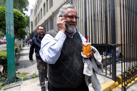 Miguel Alvarez, member of the National Mediation Commission (CONAMED), following clashes in southern Mexico when police and members of a teachers' union faced off in violent confrontations, speaks on a mobile phone as he enters the Interior Ministry building to attend a meeting with Mexico's government in Mexico City, Mexico, June 30, 2016. REUTERS/Edgard Garrido