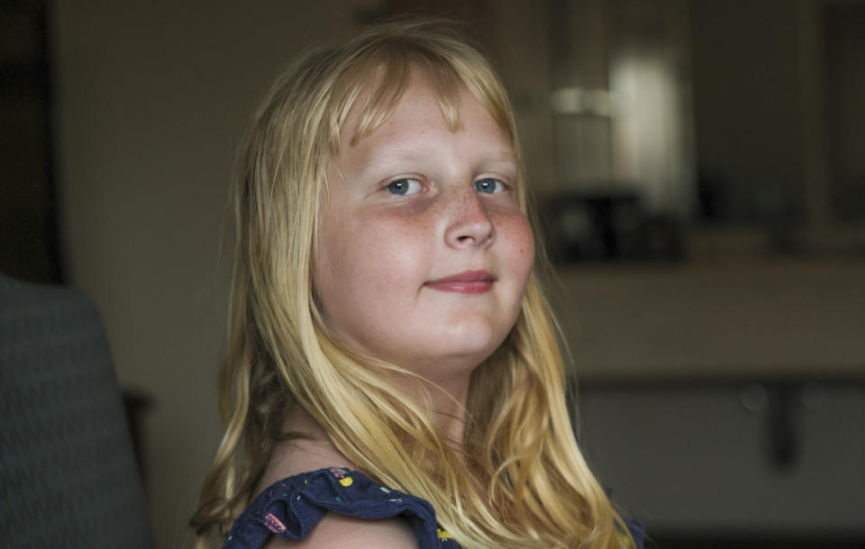 Flower Nichols, an 11-year-old transgender girl, poses for a portrait in Chicago on June 13, 2023. Families around the U.S. are scrambling to navigate new laws that prohibit their transgender children from accessing gender-affirming care. At least 20 states are moving to ban or restrict such care for minors. (AP Photo/Teresa Crawford)