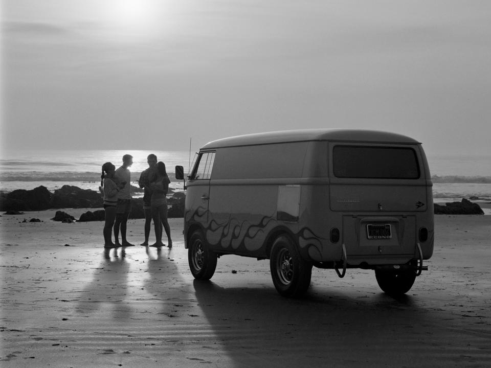 Sunset on a Southern California beach with the US Rubber Custom VW Volkswagen Bus and a group of young surfers