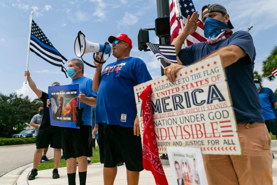 Ricky Dee, 40, center, and Seth Feder, 40, right, both Coral Springs residents, attend a Back The Blue rally near Marjory Stoneman Douglas High School in Parkland, Florida on Saturday, July 11, 2020.