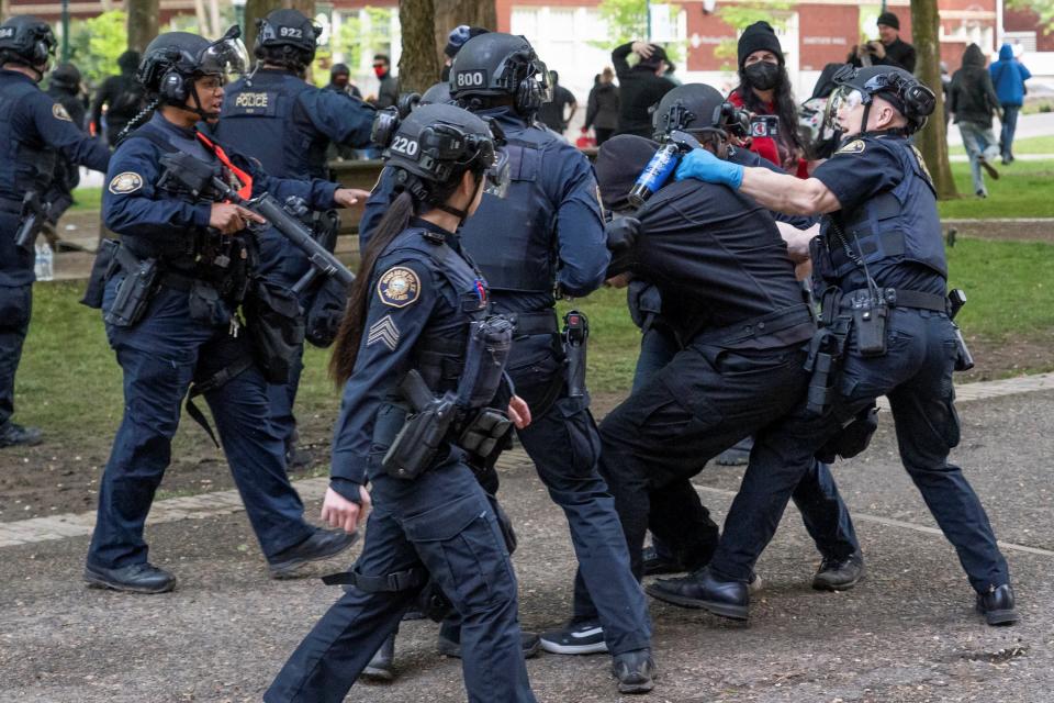 Portland Police detain a protester who re-occupied the Portland State University Library building with others after it had been cleared and several protesters were detained earlier in the day, during the ongoing conflict between Israel and the Palestinian Islamist group Hamas, in Portland, Oregon, U.S., May 2, 2024 (REUTERS)