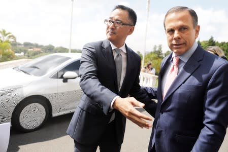President of Toyota in Brazil, Rafael Chang, gestures next to the governor of Brazil's Sao Paulo state Joao Doria, as he announces a Brazilian vehicle which is equipped with the hybrid technology during a news conference in Sao Paulo