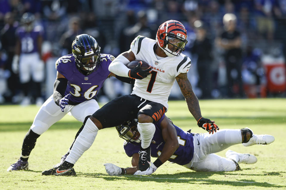 Baltimore Ravens safety Chuck Clark (36) and cornerback Marlon Humphrey (44) miss a tackle of Cincinnati Bengals wide receiver Ja'Marr Chase (1) before he took off for a long touchdown on a reception during the second half of an NFL football game, Sunday, Oct. 24, 2021, in Baltimore. (AP Photo/Gail Burton)