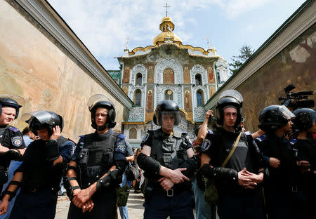 Interior Ministry members stand guard near the Kiev Pechersk Lavra monastery on the day of the election of the Primate of the Ukrainian Orthodox Church of the Moscow Patriarchate, in Kiev, Ukraine August 13, 2014. Picture taken August 13, 2014. REUTERS/Gleb Garanich