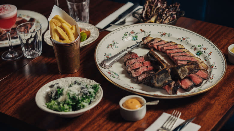 Sliced steak with chips and salad