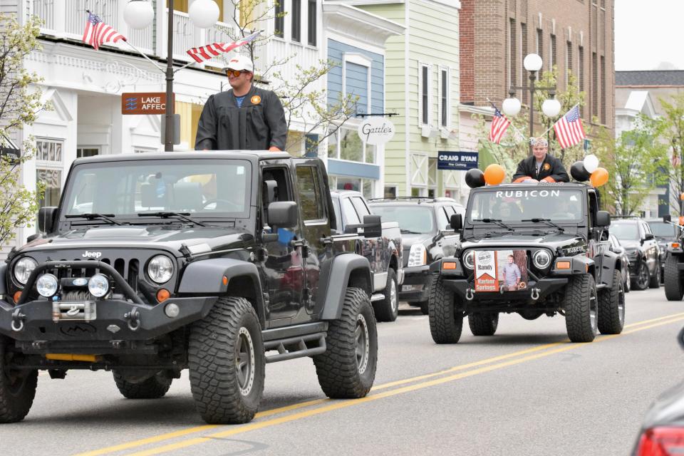 Harbor Springs High School seniors Donovan Sylvain (front) and Randy DeGayner (back) ride down Main Street in the Harbor Springs Graduation Parade on Thursday, May 26.