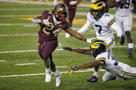 Minnesota running back Mohamed Ibrahim (24) runs for a touchdown past Michigan defensive backs Daxton Hill (30) and Makari Paige (7) in the second quarter of an NCAA college football game Saturday, Oct. 24, 2020, in Minneapolis. (AP Photo/Bruce Kluckhohn)