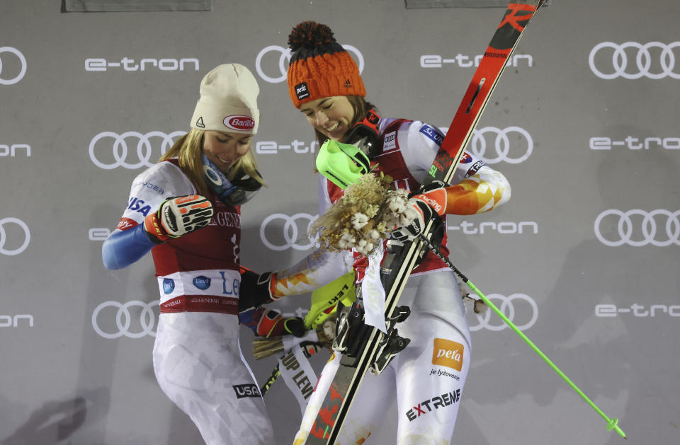 Slovakia's Petra Vlhova, right, winner of an alpine ski, World Cup women's slalom, celebrates on the podium with second placed United States' Mikaela Shiffrin, in Levi, Finland, Sunday, Nov. 21, 2021. (AP Photo/Alessandro Trovati)