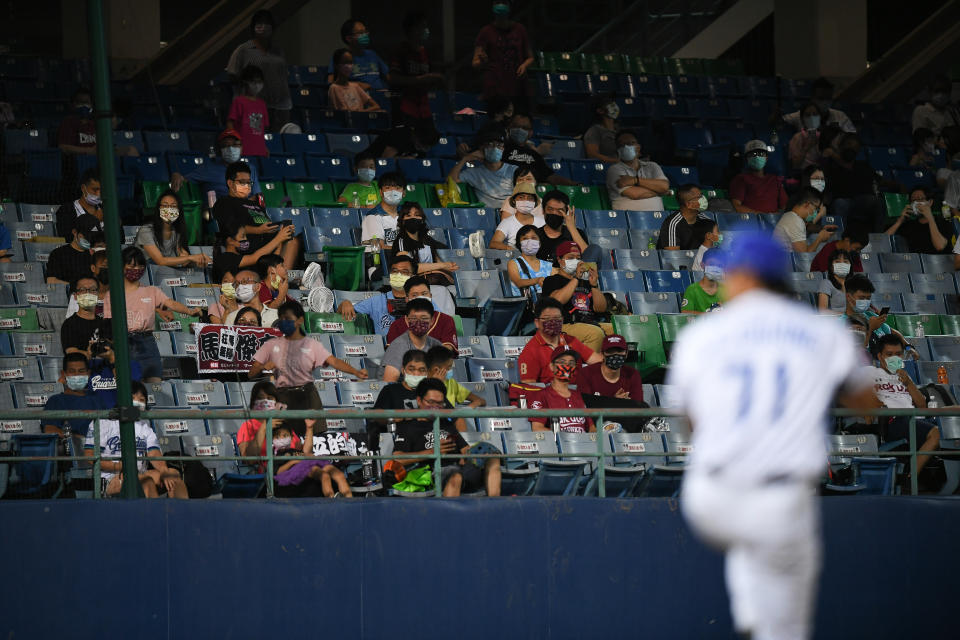 NEW TAIPEI CITY, TAIWAN - SEPTEMBER 20: Fans wearing the facemask watching at the court when pitcher Chiang Shao-Ching #71 of Fubon Guardians pitching at the top of the 5th inning during the CPBL game between Rakuten Monkeys v Fubon Guardians at Xinzhuang Baseball Stadium on September 20, 2021 in New Taipei City, Taiwan. (Photo by Gene Wang/Getty Images)