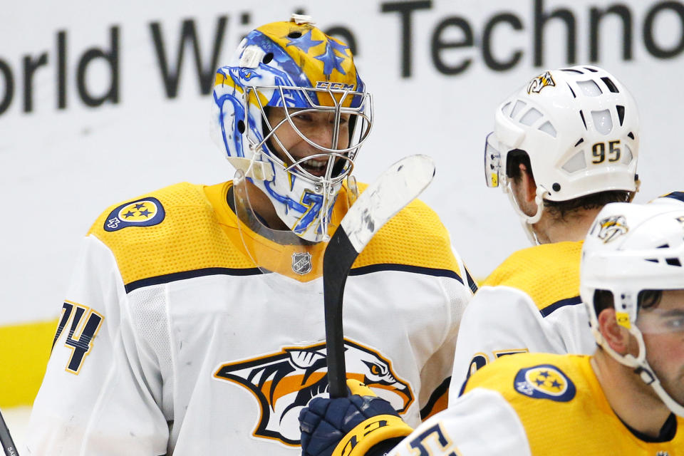 Nashville Predators goaltender Juuse Saros, of Finland, is congratulated by teammates after the Predators defeat the St. Louis Blues in an NHL hockey game Saturday, Feb. 15, 2020, in St. Louis. (AP Photo/Billy Hurst)