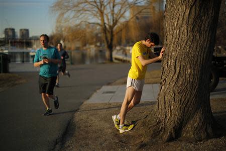 David Chorney stretches before a training run for the Boston Marathon in Boston, Massachusetts, April 3, 2014. REUTERS/Brian Snyder