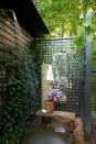 <p>For a garden effect in a wooded area, use exterior walls and trellises. Here, designer <a href="https://www.housebeautiful.com/design-inspiration/house-tours/a36552000/hadas-dembo-hillsdale-new-york-home/" rel="nofollow noopener" target="_blank" data-ylk="slk:Hadas Dembo;elm:context_link;itc:0" class="link ">Hadas Dembo</a> used two trellises to create a privacy screen around an outdoor shower. The trellises promote greenery growth. A large potted succulent breaks up the verdant surrounding.</p>