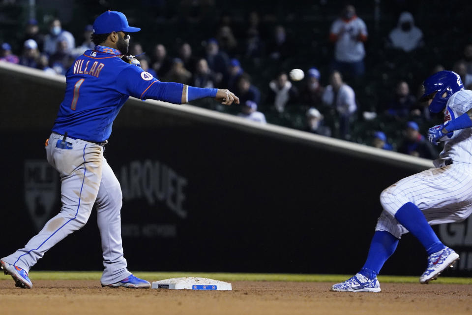 New York Mets second baseman Jonathan Villar (1) forces out Chicago Cubs' Javier Baez (9) at second base and then throws to first base to complete a double play during the seventh inning of a baseball game, Thursday, April, 22, 2021, in Chicago. (AP Photo/David Banks)