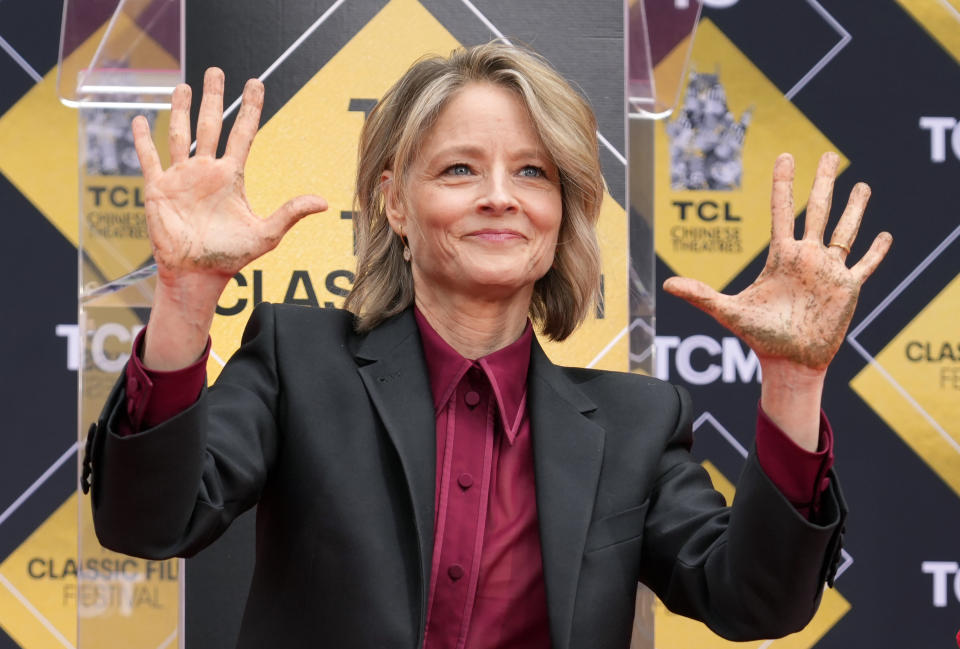 Jodie Foster holds up her hands after putting them in cement during her hand and footprint ceremony at the TCL Chinese Theatre, in Los Angeles, April 19, 2024. (AP Photo/Chris Pizzello)